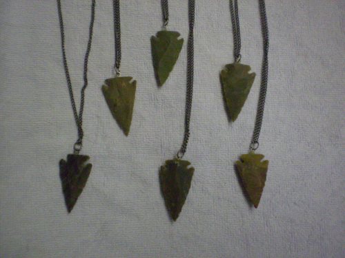 Chipped stone arrowhead pendants, on cord.
